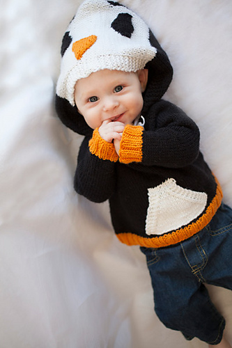 Knitting pattern for Happy Penguin Hoodie Sweater Child's pullover sweater in sizes Newborn (3 months, 6 months, 9 months, 12 months) 2, 4, 6, 8, 10 years. Hood looks like the penguin's head while pocket panel in the front is colored white like a penguin's breast.
