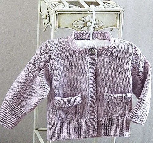 Knitting pattern for cute child's cardigan sweater featuring cable detail on the sleeves and pockets. 0-6 months, 6-12 months, 1-2 years, 2-3 years, 4-5 years, 6-7 years