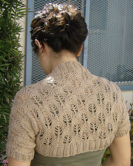 Free knitting pattern for Something Lacy Shrug, easy candle flame lace shrug pattern